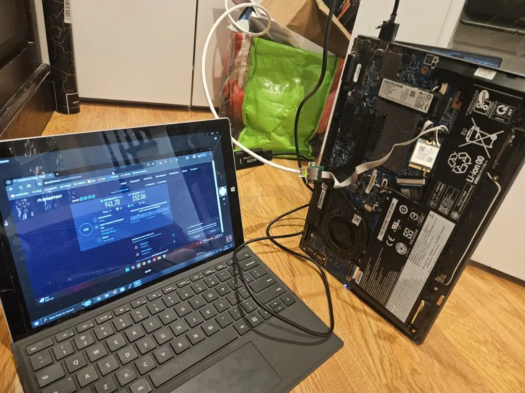 Laptop with its Wi-Fi card replaced by a wired Ethernet adapter