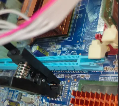 SOP8 clip attached to a motherboard BIOS chip